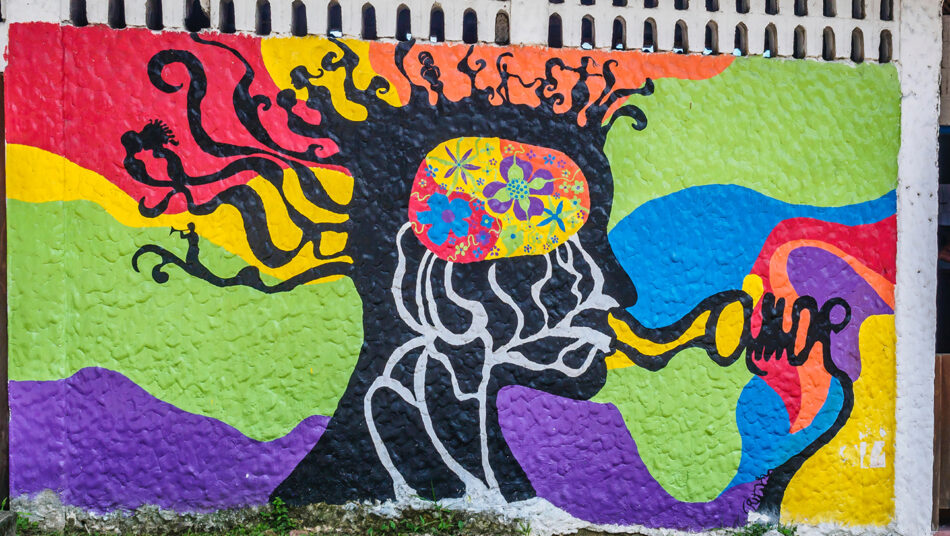 A colorful mural depicting a man smoking a cigarette.