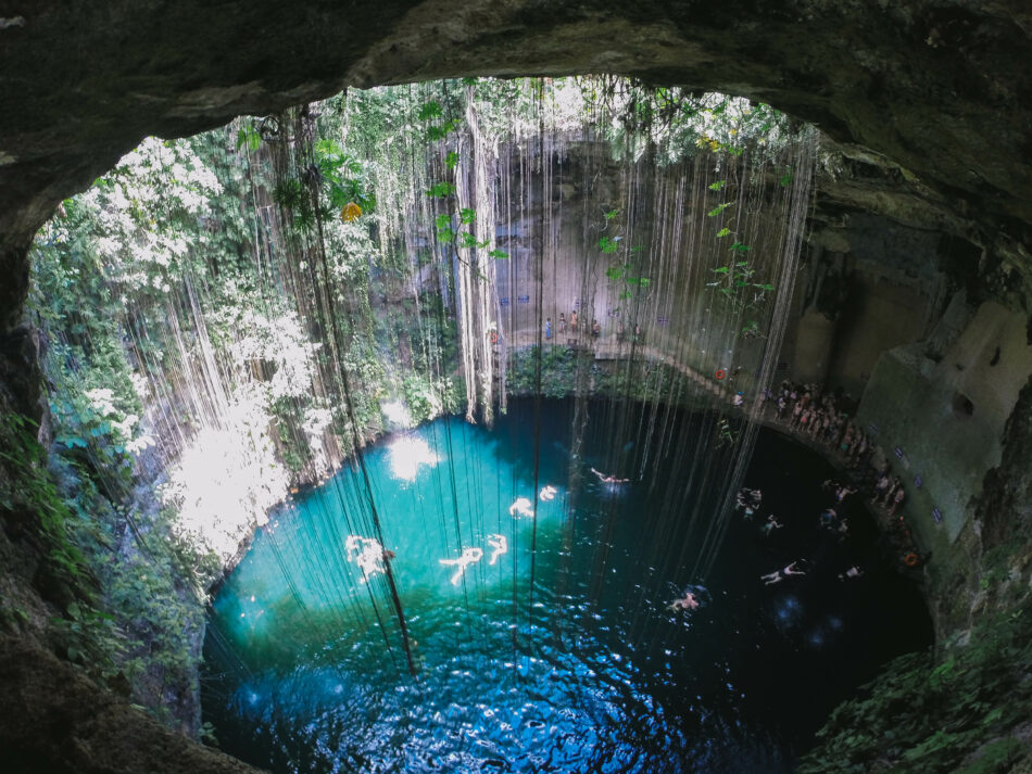 Explore an exotic cave pool with a group of people.