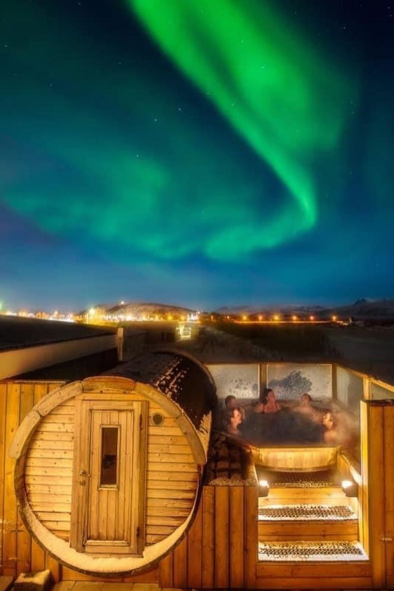 Aurora bore over a hot tub in iceland.