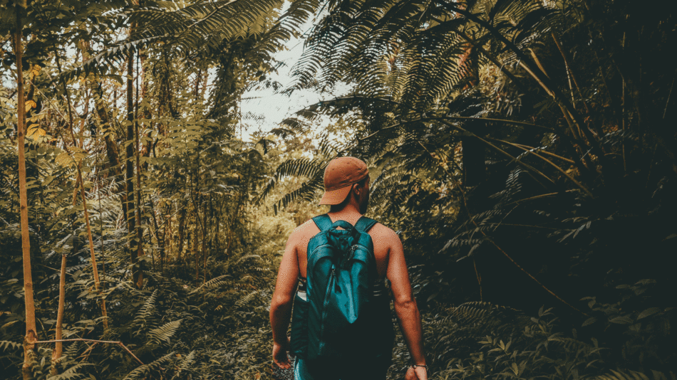 A man explorning hidden gems in Hawaii with a backpack.