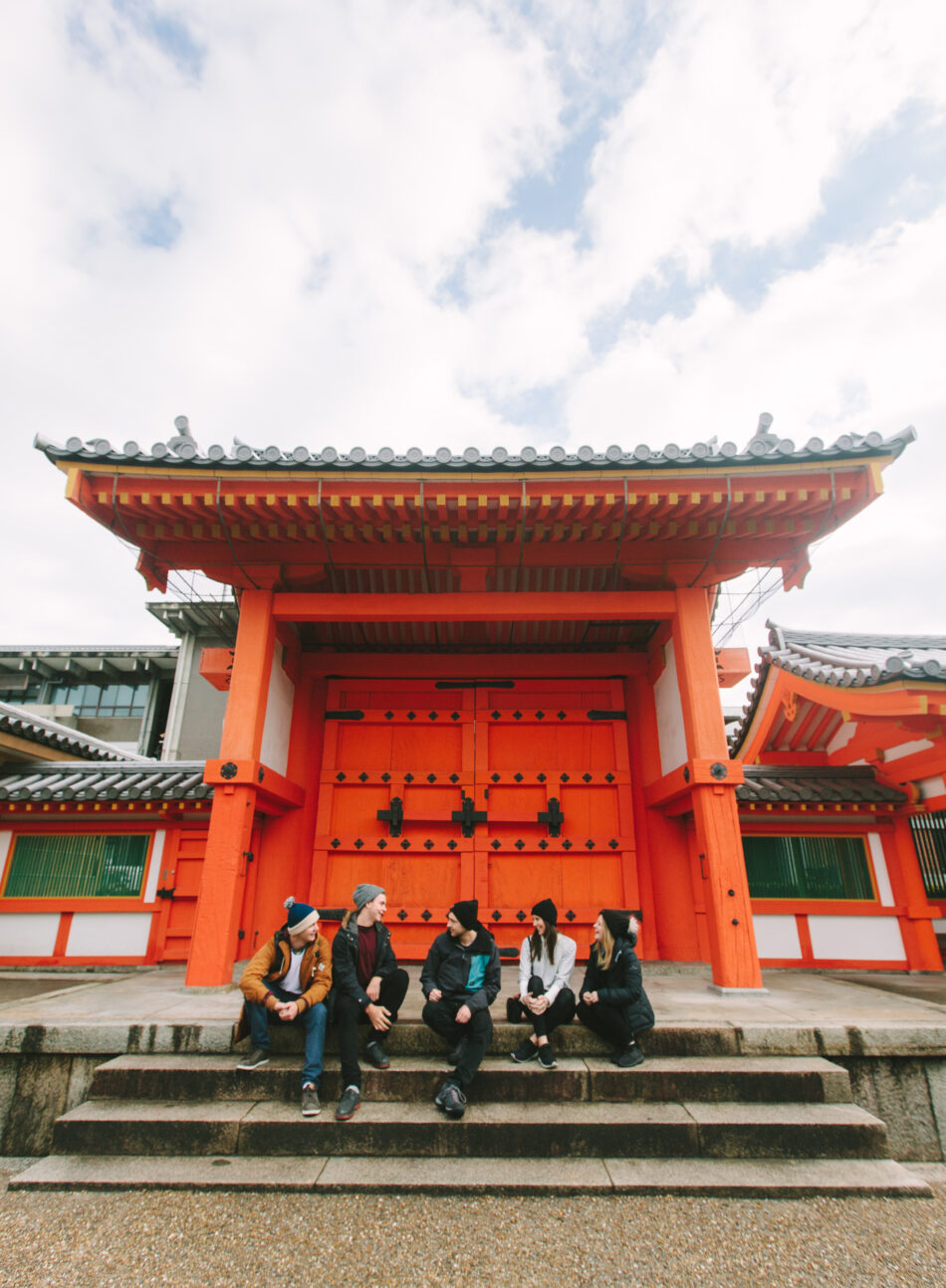 A group of people from Japan sitting on steps.