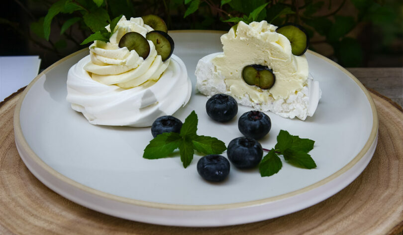 Two mouthwatering desserts, perfectly plated with a sprinkle of fresh blueberries and a hint of refreshing cucumbers.