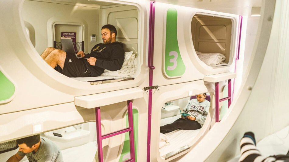 A group of people sitting on bunk beds in a room.