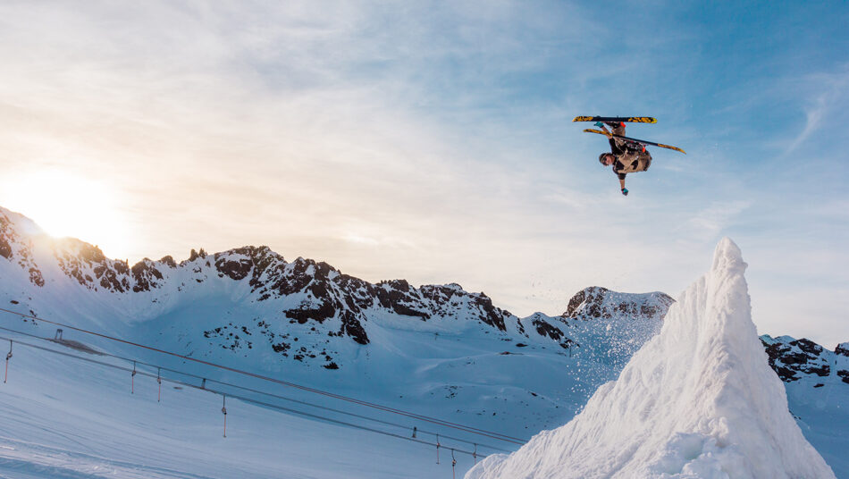 A person performing an awe-inspiring snowboard trick in the air.