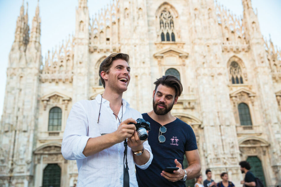 Two men taking a photo of Milan Duomo