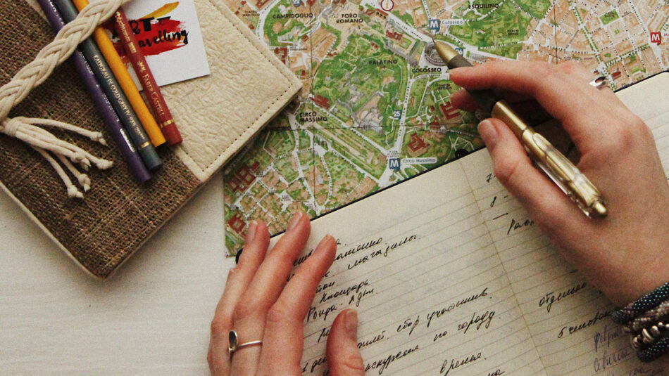 A woman's hand writing on a map.