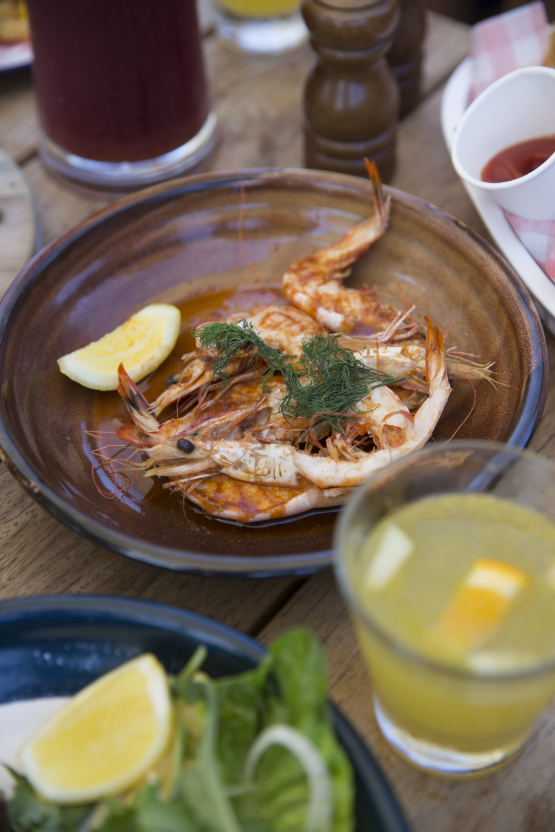 A plate of food on a wooden table adorned with Christmas decorations.