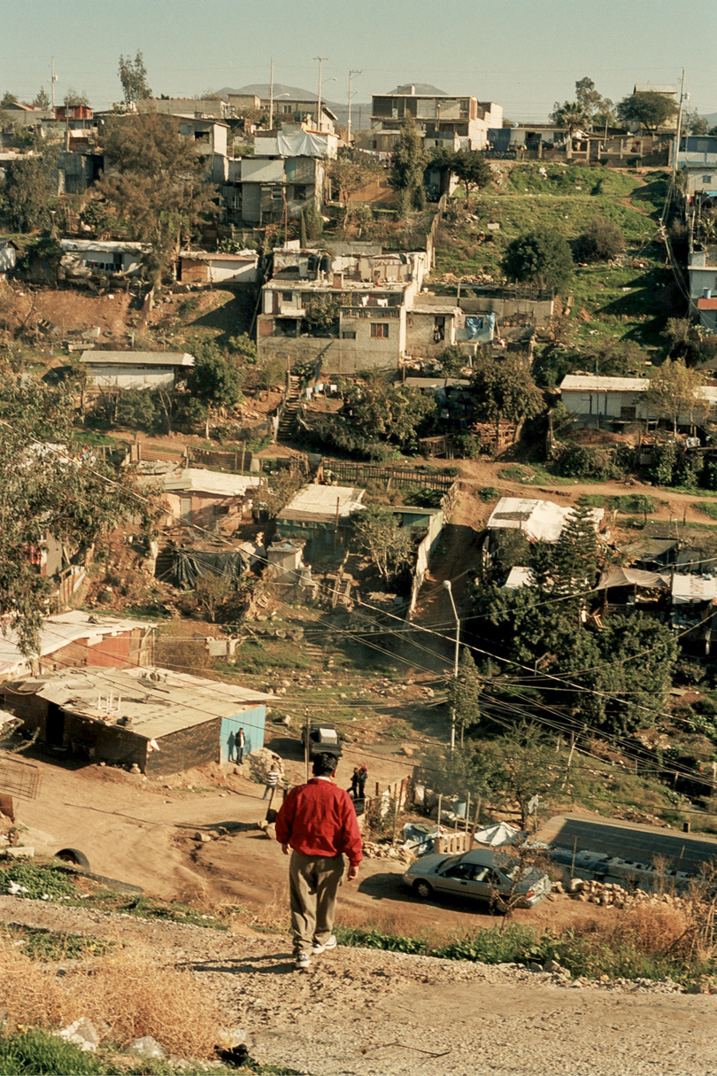 A man walking down a dirt road.