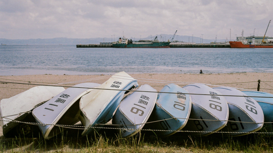 A group of boats on a beach.