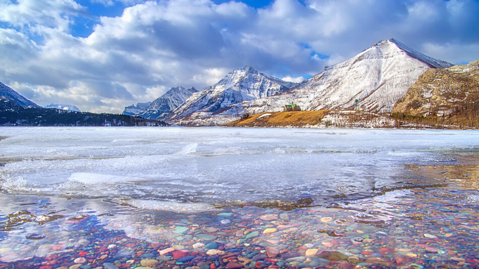 A lake surrounded by mountains and ice.