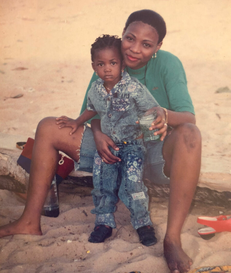 A woman and a child sitting on the beach.