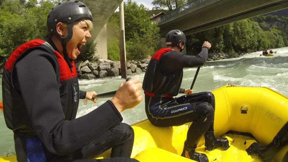 adventure travel - image of a girl white water rafting