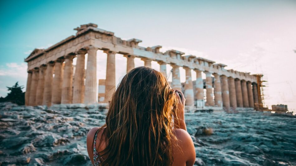 girl photographing a temple in Athens, Greece