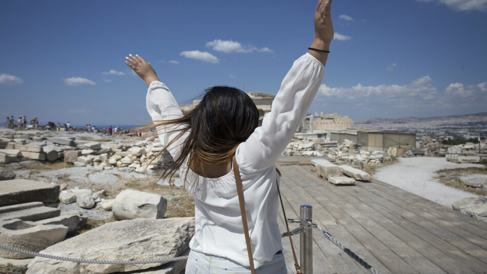 A woman joyfully celebrating in one of the best summer destinations in Europe.