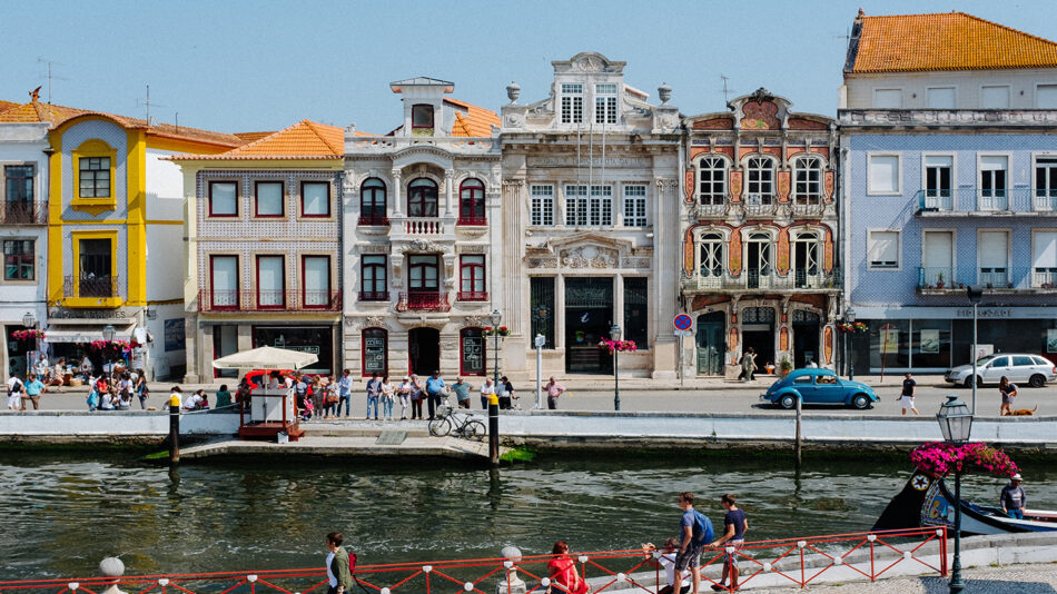 A group of people are walking along a river in one of the cheapest countries in Europe.