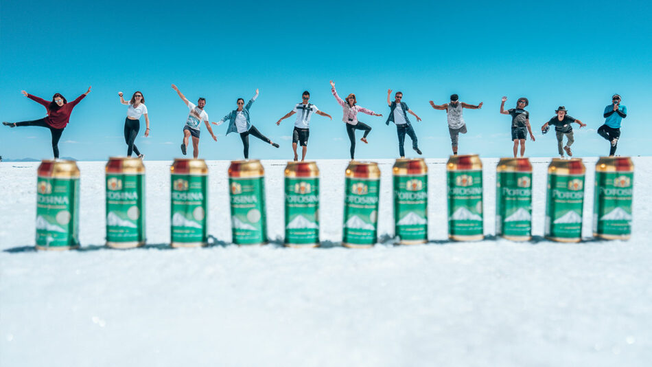 A group of people standing in front of a group of cans.