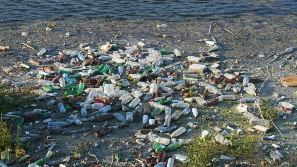 A heap of plastic bottles on the ground in relation to ocean pollution.