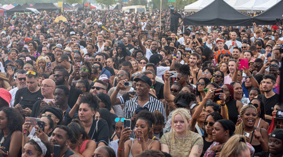 A vibrant crowd at a UK music festival, celebrating diversity and inclusion during Black Pride.