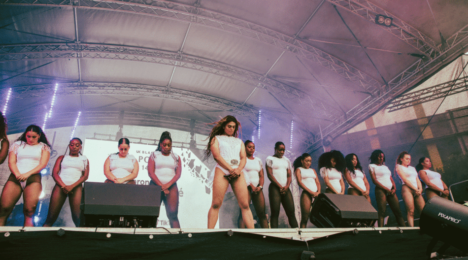 A group of women celebrating UK Black pride on a stage.