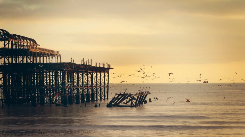 A picturesque pier with birds flying over it, perfect for a peaceful holiday getaway.