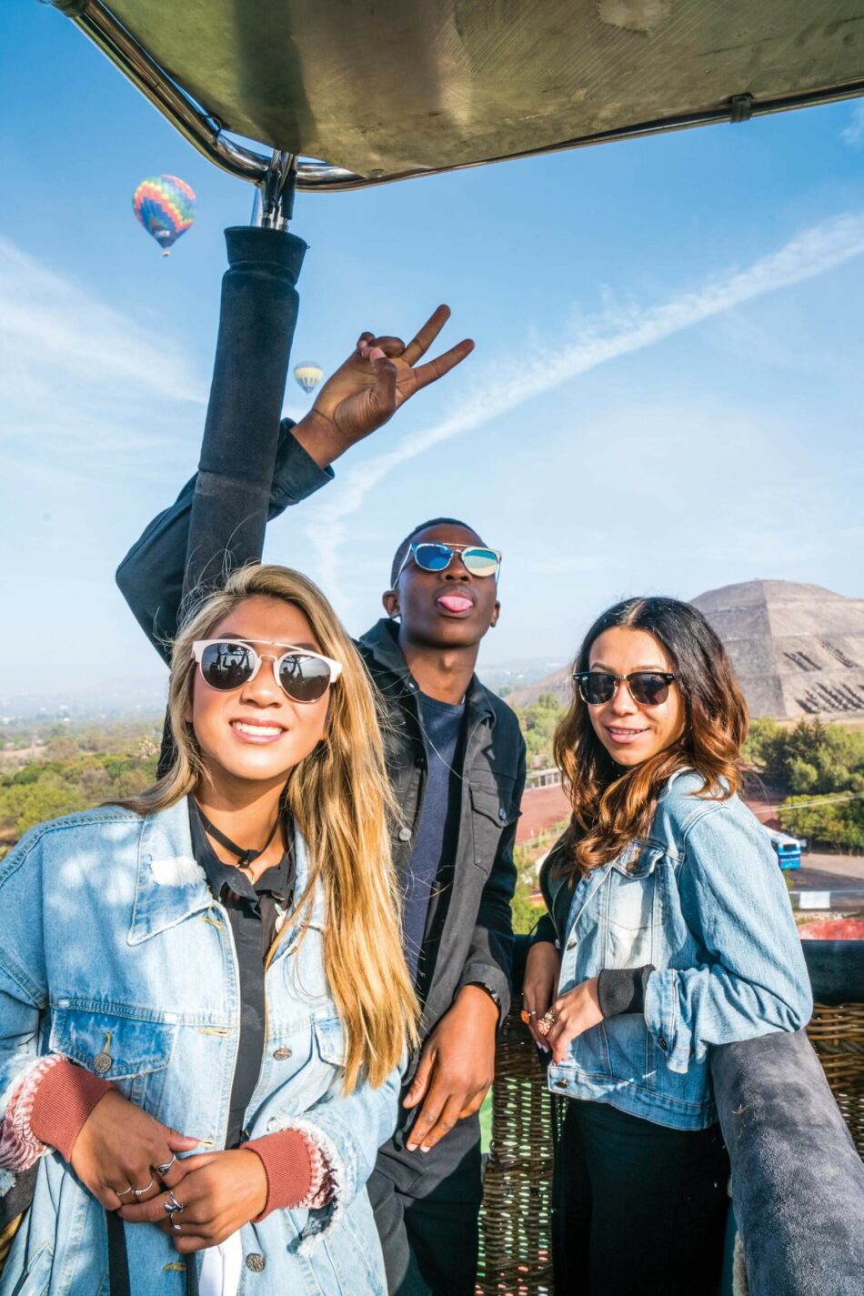 A group of people posing for a photo on a hot air balloon.