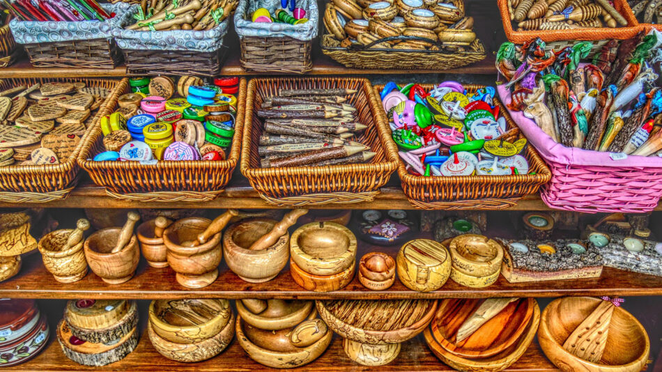 A wooden shelf with a variety of items on it.