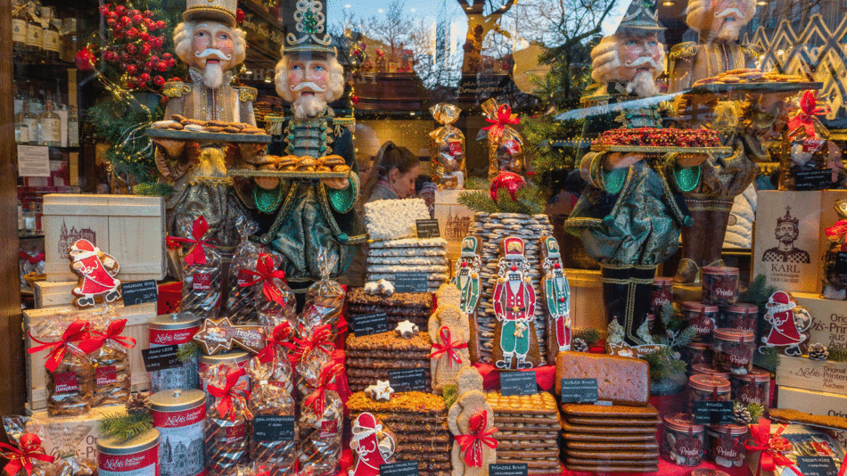 A window display featuring an array of German Christmas decorations, including traditional holiday ornaments and festive lights.