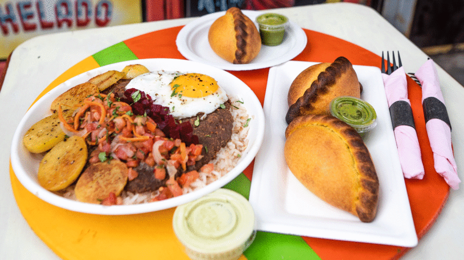 The best plate of food in the Bronx and Queens, elegantly presented on a table with a fork and spoon.