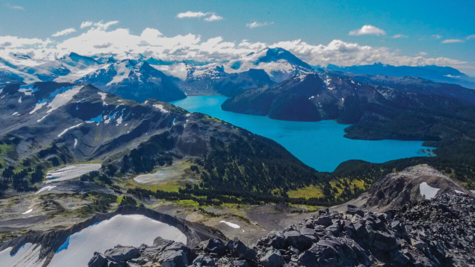 An aerial view of a mountain range and one of the best lakes in Canada.