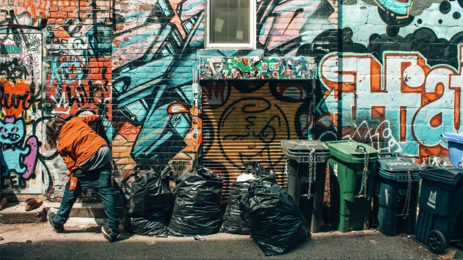 man spray painting in Grafitti Alley, Toronto, Canada