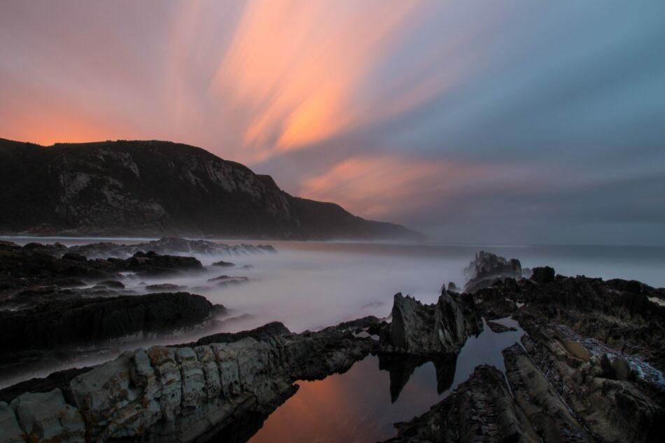 A sunset over a rocky beach along the Garden Route.