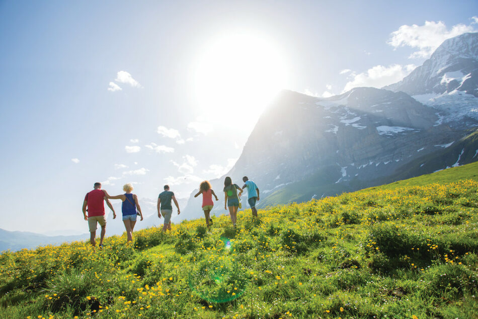 A group of active people walking in a field.