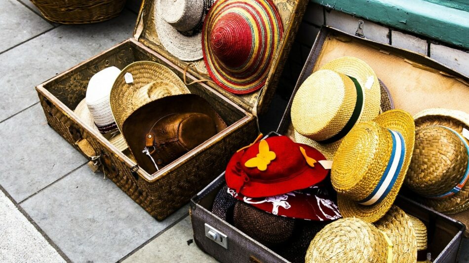 Hats in a suitcase on a sidewalk in South America.