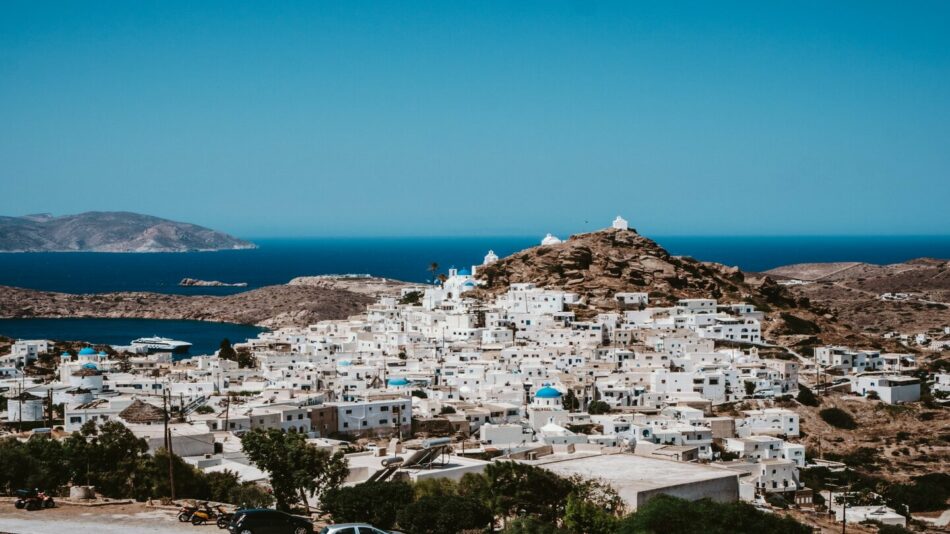 A view of a white village on a hill overlooking the sea.