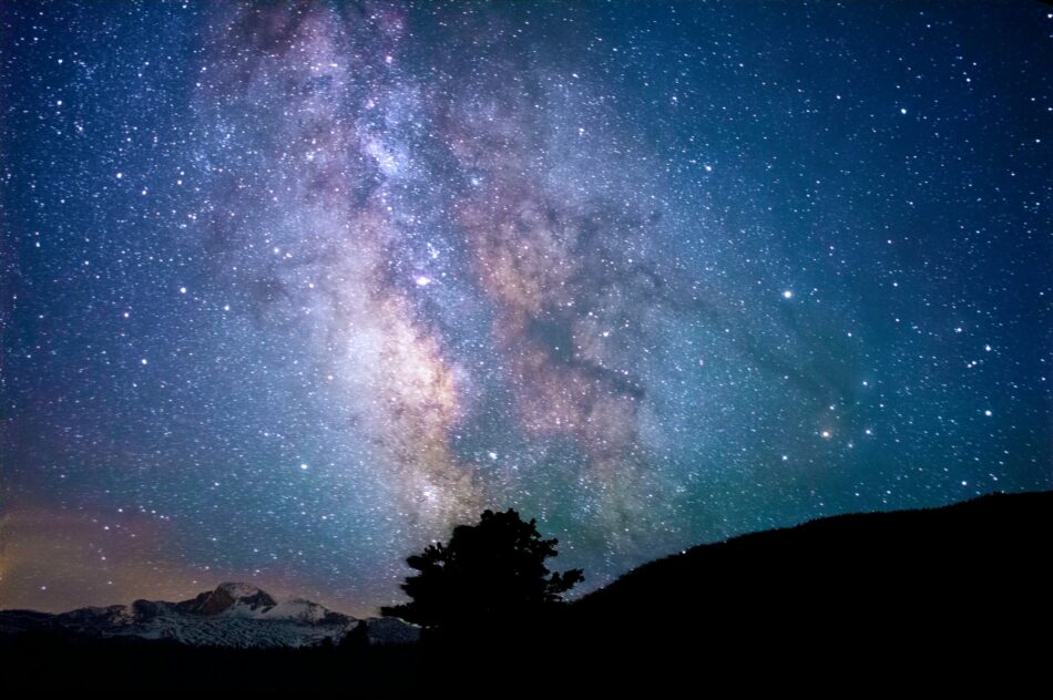 The milky above a mountain in the night sky.