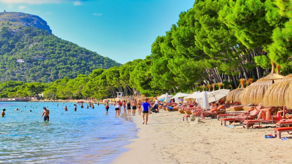 people enjoying nice weather at mallorca beach, spain