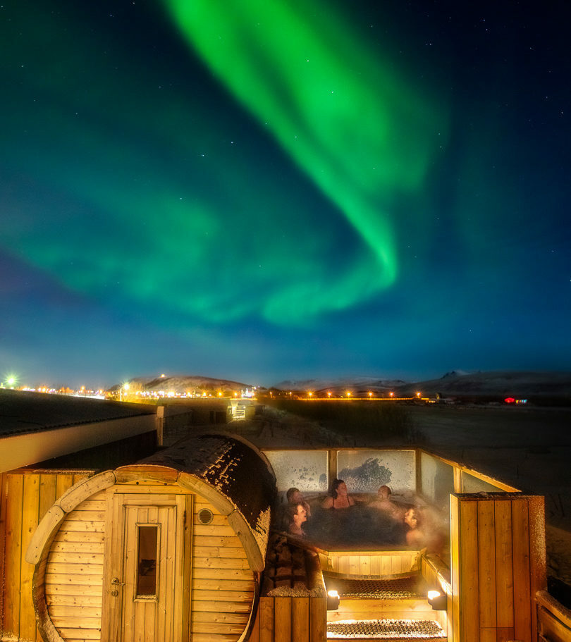 Aurora bore over a hot tub in iceland.