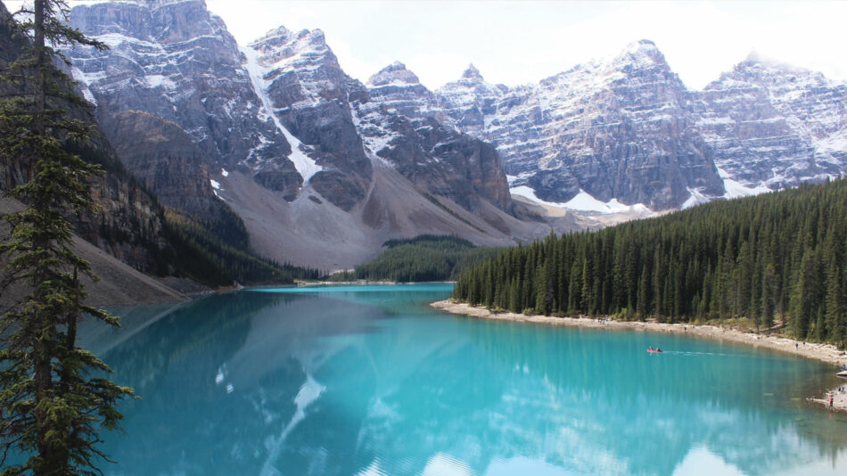 One of the best lakes in Canada, a serene blue body of water embraced by majestic mountains and lush trees.