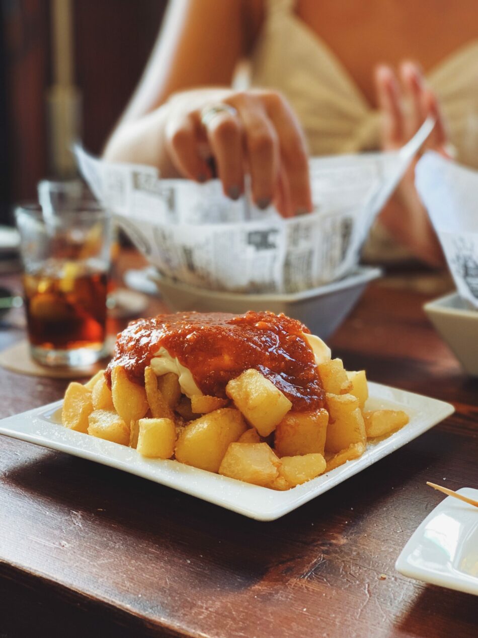 A plate of chicken and potatoes on a table.