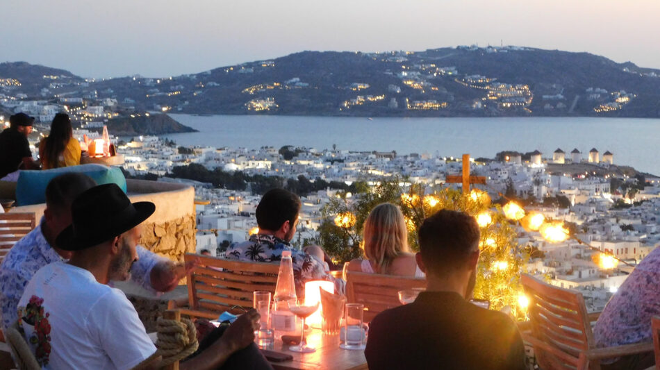 Mykonos by night - people drinking and looking at the sea