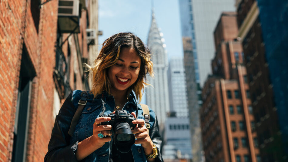 things to do in New York - image of girl looking at camera with empire state building in the background