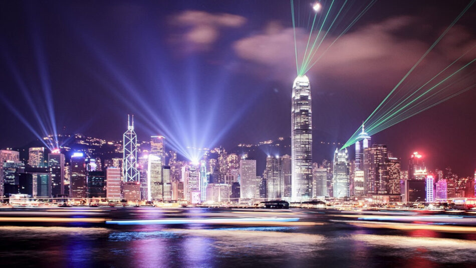 The skyline of Hong Kong is illuminated at night.