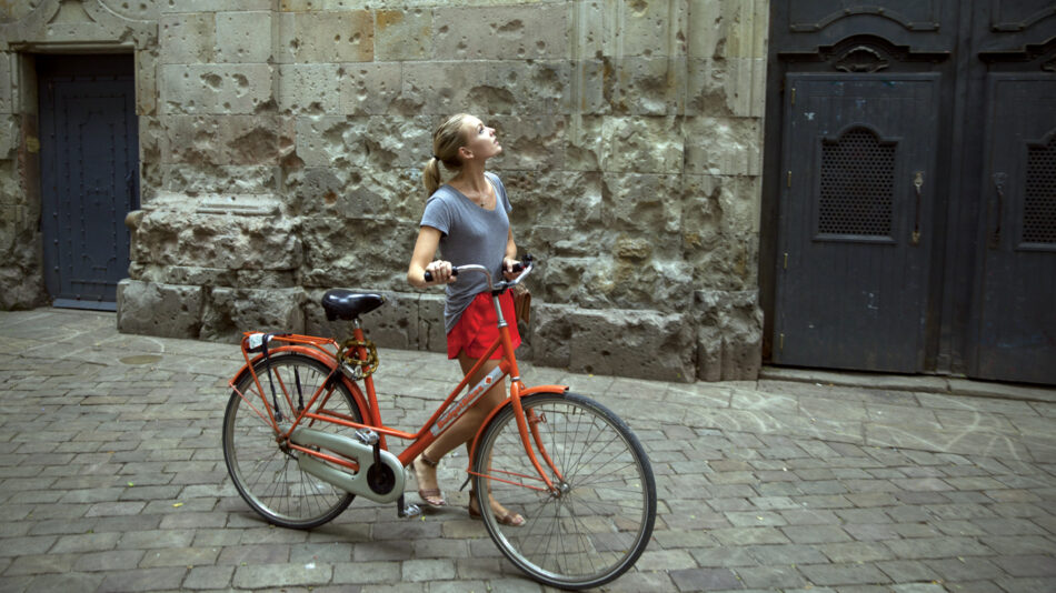 Image of a girl pushing a bike