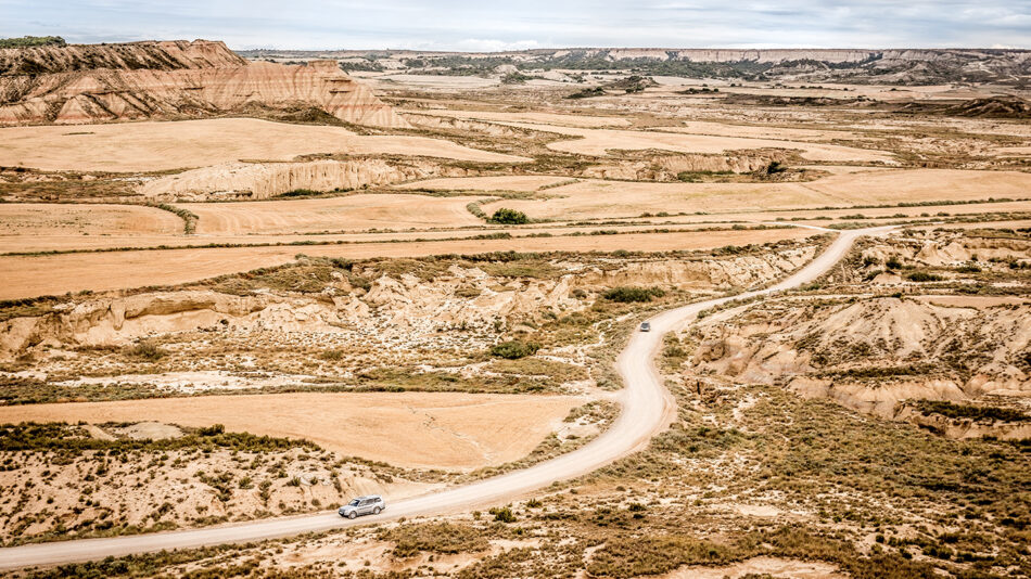 A car driving down a dirt road in a desert, passing by Spanish Game of Thrones filming locations.