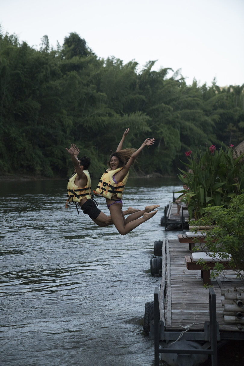 Two people jumping into a body of water in Chiang Mai.