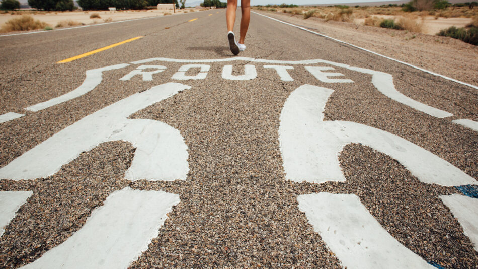 the USA best RoadTrip's - close up shot of feet walking on the Route 66 sign