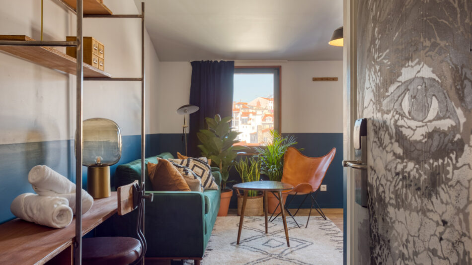 A living room with blue walls and a couch.