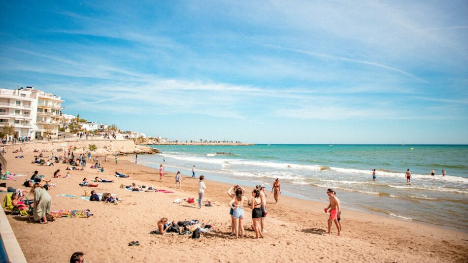 people enjoying the beach in Sitges, Spain