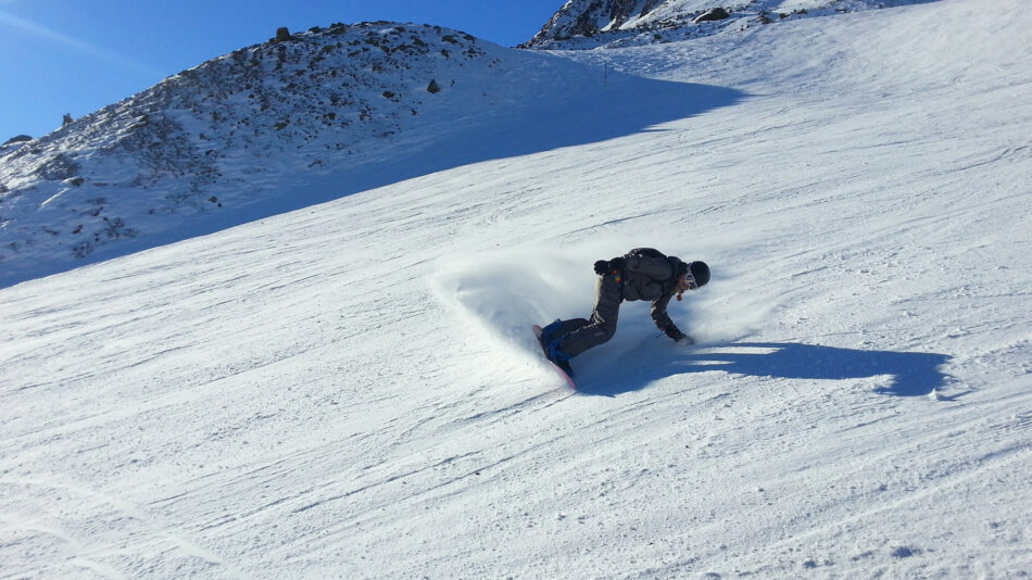 A person skiing down a snowy slope in Austria.