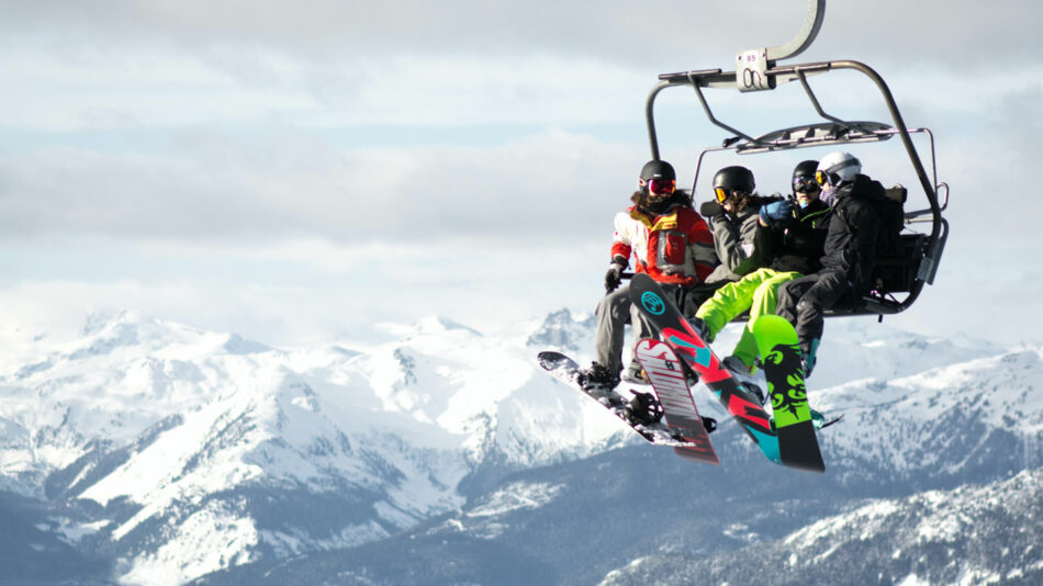 A group of people sitting on a ski lift.